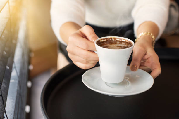 istock woman hands with turkish coffee on black table 1366873078