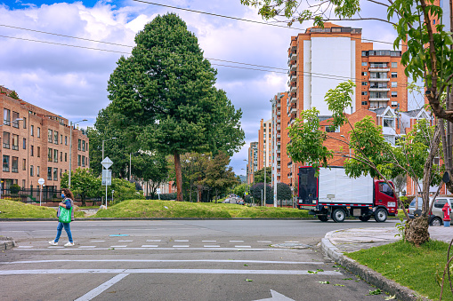 Bogotá, Colombia - September 24, 2021: The drivers point of view at the point where Calle 152 joins Carrera Novena on the northbound carriageway of the Carrera driving through the Cedritos area in the Andean capital city of Bogota, in South America. There are residential buildings on either side of the road. The altitude at street level is 8660 feet above mean sea level. Horizontal format. Copy space.