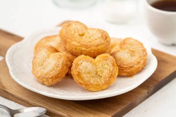 Photo of Delicious Palmier butterfly pastry in heart shape for Valentine's day dessert.