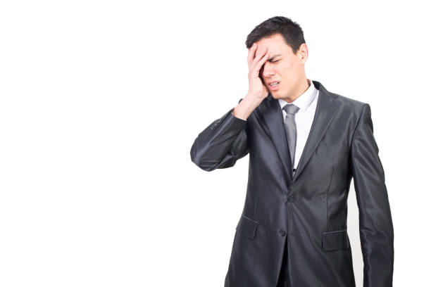 istock Tired man in suit suffering from headache 1366888451