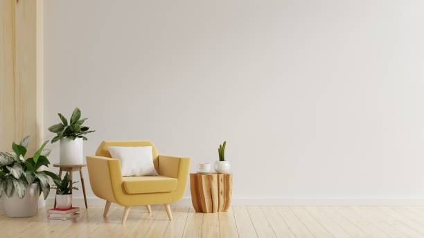 istock Modern minimalist interior with yellow armchair on empty white wall. 1366892405
