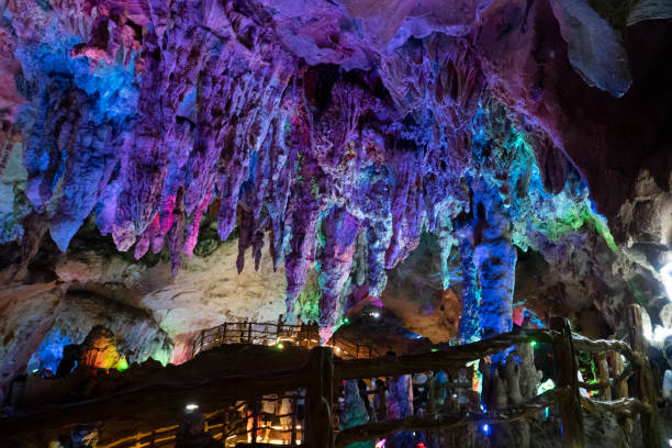 istock Underground karst cave illuminated by color light 1366892440