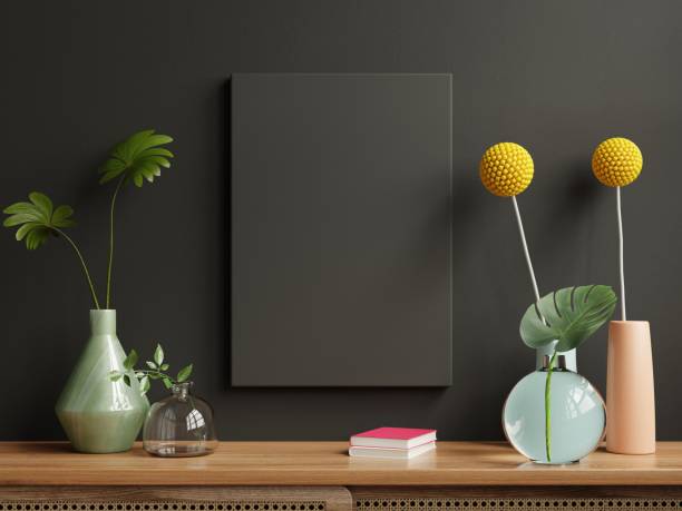 istock Mockup black frame on cabinet in living room interior on empty dark wall background. 1366892441