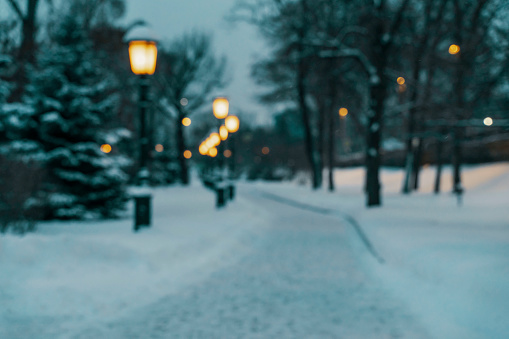 snow-covered alley in the alexandrovsky garden on a winter night in the center of moscow. blur background