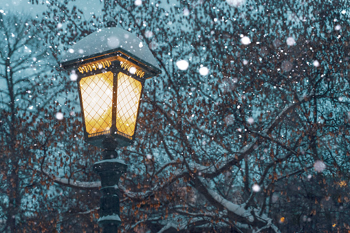 Lights at night on the streets of a snow-covered city in winter. fluffy white snow circles