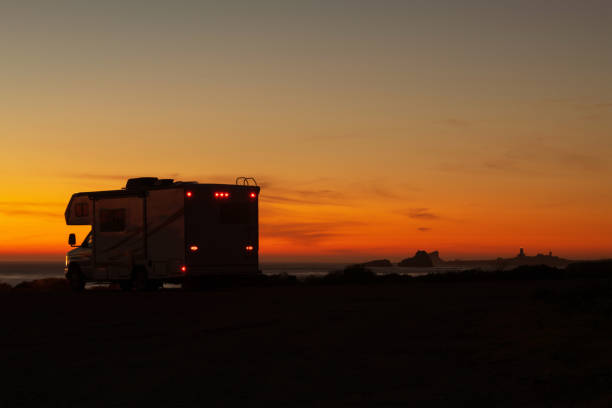 istock Scenic Ocean Shore Sunset and Camper Van Class C RV 1366894259