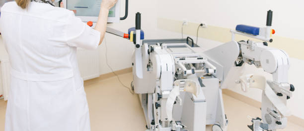 istock Patient on Continuous Passive Range of Motion machines. Device to provide anatomically correct motion to both the ankle and joints. Foot rehabilitation simulator after injured. Ligament treatment 1366894283