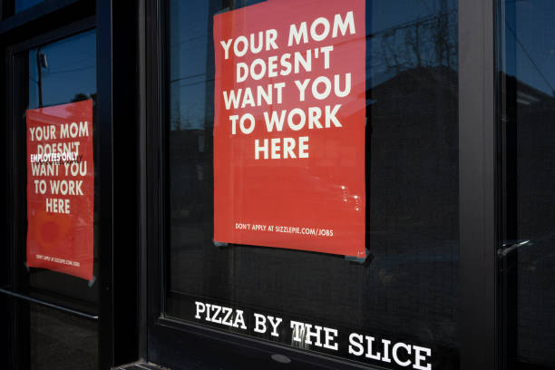 Beaverton, OR, USA - Jan 25, 2022: Creative hiring ads are seen at the Sizzle Pie restaurant in Beaverton, Oregon, amid a nationwide labor shortage. Sizzle Pie is an American regional pizza chain.
