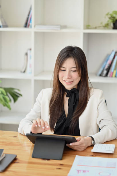 istock Confident businesswoman using digital tablet at office. 1366902167