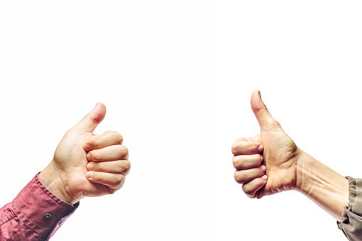Hands showing thumbs up sign against isolated on white background. Woman and man showing OK sign