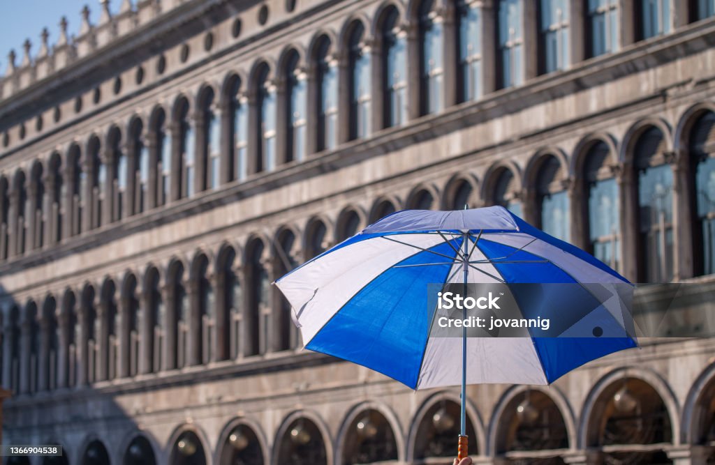 Black, white and blue umbrella in St Mark Square for Mardi Gras parade, Venice - Italy. Black, white and blue umbrella in St Mark Square for Mardi Gras parade, Venice - Italy Architecture Stock Photo