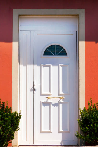 istock Front door on orange painted facade. 1366913490
