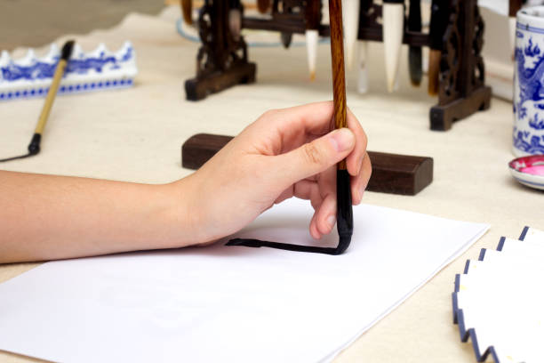 istock Traditional Chinese calligraphy Master writing a character. Asian art equipment and tools 1366913506