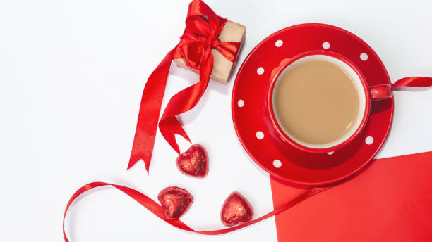 istock Red envelope with blank white note mockup inside, a cup of coffee and on white background. Valentines day, love, anniversary concept 1366913794