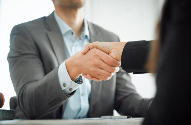 istock Shot of two businesspeople shaking hands 1366914633