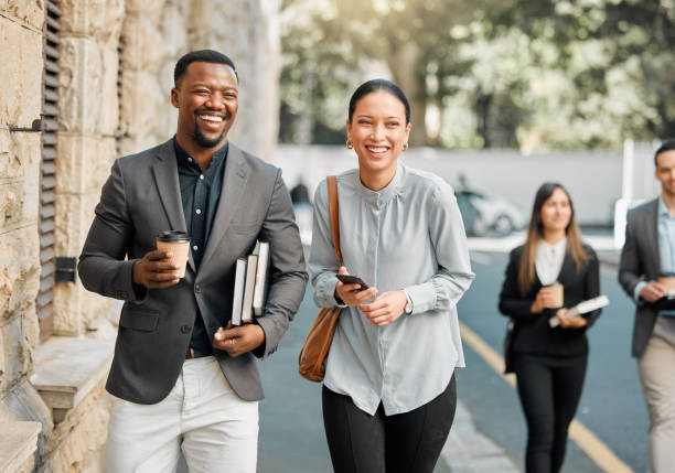 Shot of two lawyers walking to work while having a conversation
