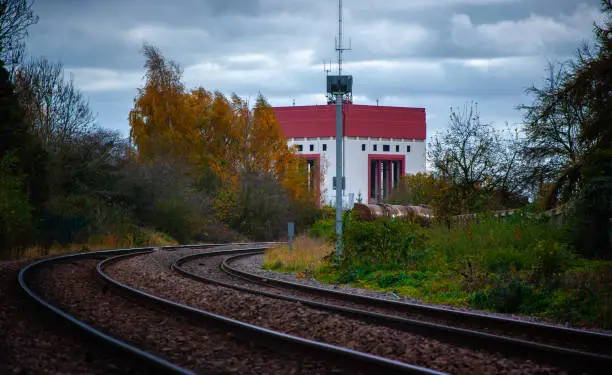 Spalding Water Tower and railway tankers as seen from the Lincoln to Peterborough Railway on an overcast autumn cloudy day; bend in track