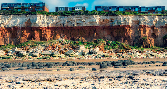 Modern flats appear to be dangerously close to the edge of the famous eroding red-brown carstone cliffs in Hunstanton, Norfolk, UK.