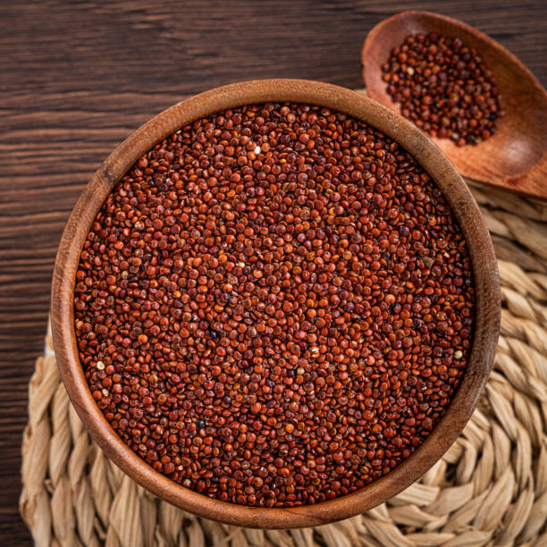 istock Organic red quinoa in a bowl on wooden table background. 1366915705