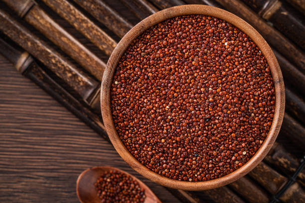 istock Organic red quinoa in a bowl on wooden table background. 1366915711