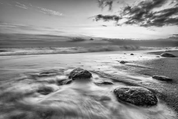 High Resolution Image Ocean Landscape With A Detailed Sand And Rock Foreground In Black And White Image Format