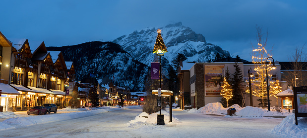 Banff, Alberta, Canada - January 10 2022 : Bus stop on Banff Avenue in winter night.