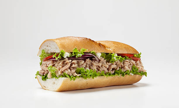 огромная бутерброд изолированные на белом фоне - sandwich tuna tuna salad sandwich salad стоковые фото и изображения