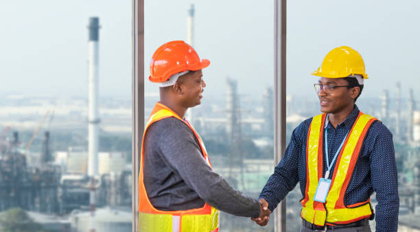 istock African American engineer and security team handshaking for agreement in partnership project for petroleum and crude oil refinery factory for power industry concept 1366919416