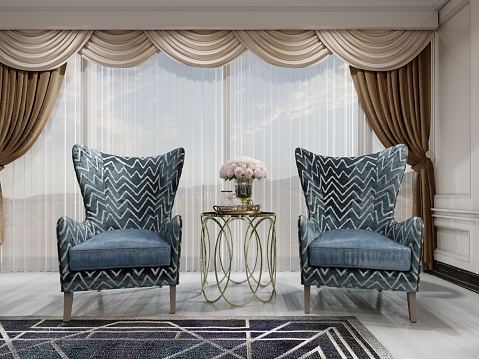 A sitting area in the bedroom with two comfortable designer blue armchairs with a gold pattern and a gilded table with a vase of pink roses and decor near the window. 3D rendering.