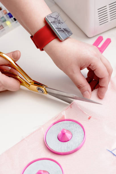 istock taking measurements on the fabric. Seamstress sewing on the sewing machine in small studio. Fashion atelier, tailoring, handmade clothes concept. Slow Fashion Conscious consumption. 1366920352