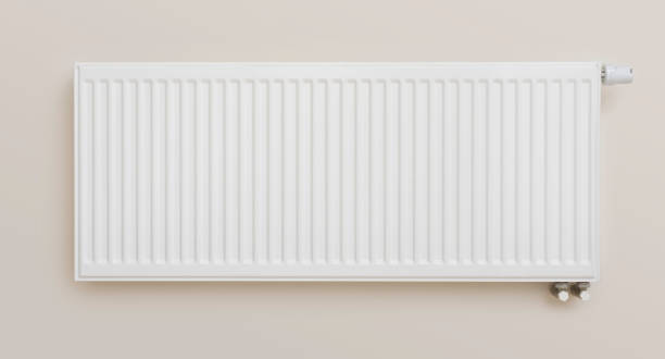 istock Heating radiator with adjusting knob installed on beige color wall 1366920696