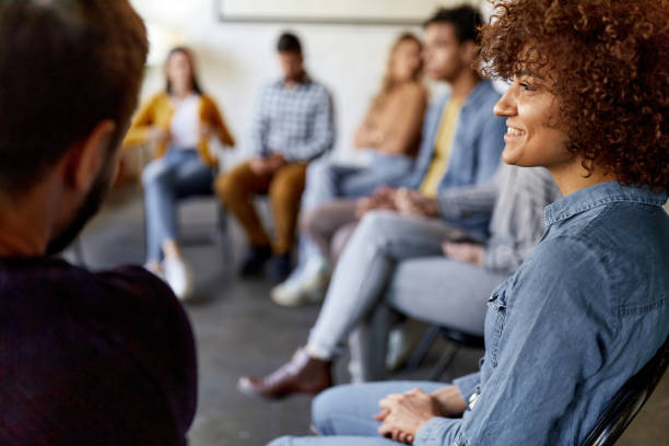 istock Happy woman attending a group therapy. 1366921216