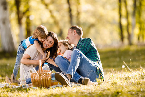 istock Cheerful family having fun on a picnic in spring day. 1366922822