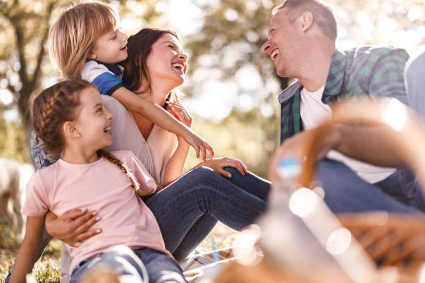 istock Cheerful parents and their small kids having fun during picnic in springtime. 1366922905