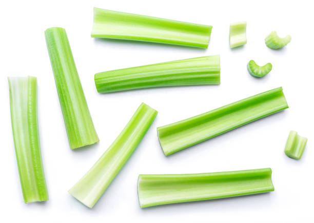Pile of celery ribs isolated on white background. stock photo
