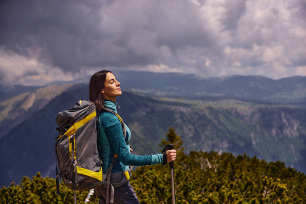 istock Female hiker with backpack relaxing and enjoying the view 1366923184
