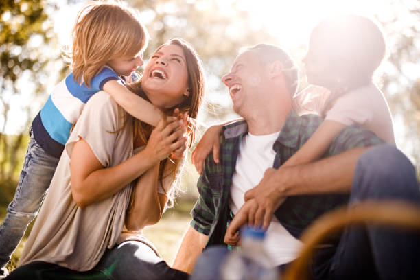 istock Cheerful family having fun while talking in spring day. 1366923273