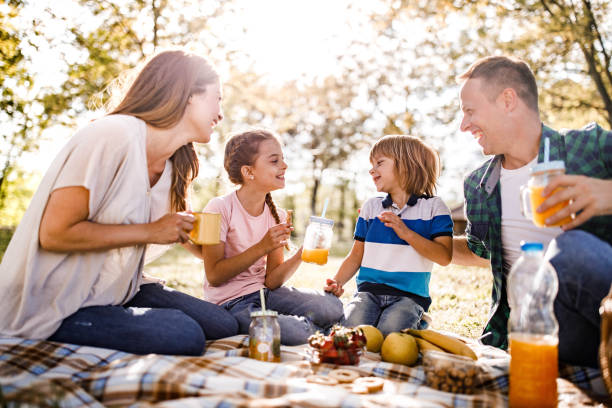 istock Happy family talking on a picnic in spring day. 1366923312