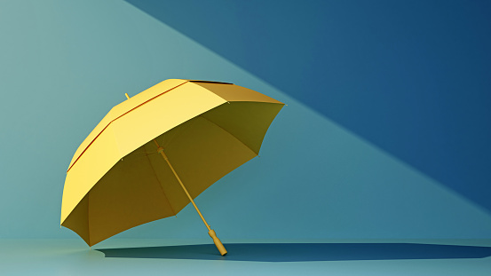 yellow umbrella under ray of sun on blue background with copy space. 3d rendering
