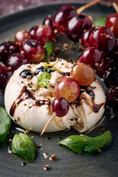 istock Burrata Cheese With Grilled Grapes and Basil Leaves 1366924513