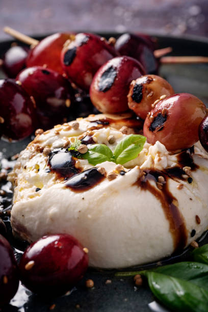 istock Burrata Cheese With Grilled Grapes and Basil Leaves 1366924565