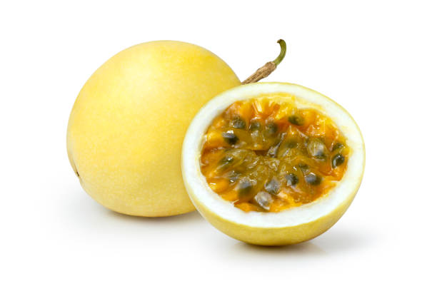 Yellow passion fruit with water droplets and chopped slice isolated on white background. stock photo