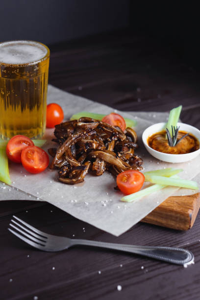 istock Selective focus on fried ear of pork with tomatoes celery and sauce sprinkled with sesame seeds 1366928484