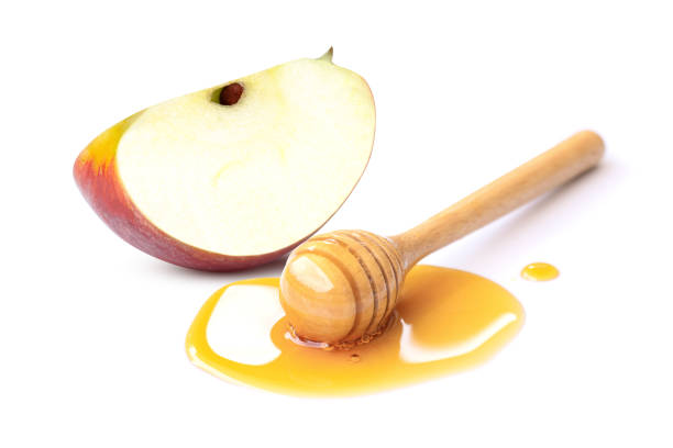 istock Apple and honey isolated on white 1366928526