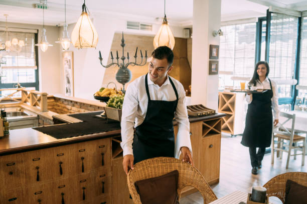 istock Waiter welcoming customers in the restaurant 1366929055