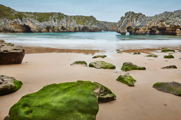 Picturesque rocky coastline in Asturias, Playa de las cuevas. Spain stock photo
