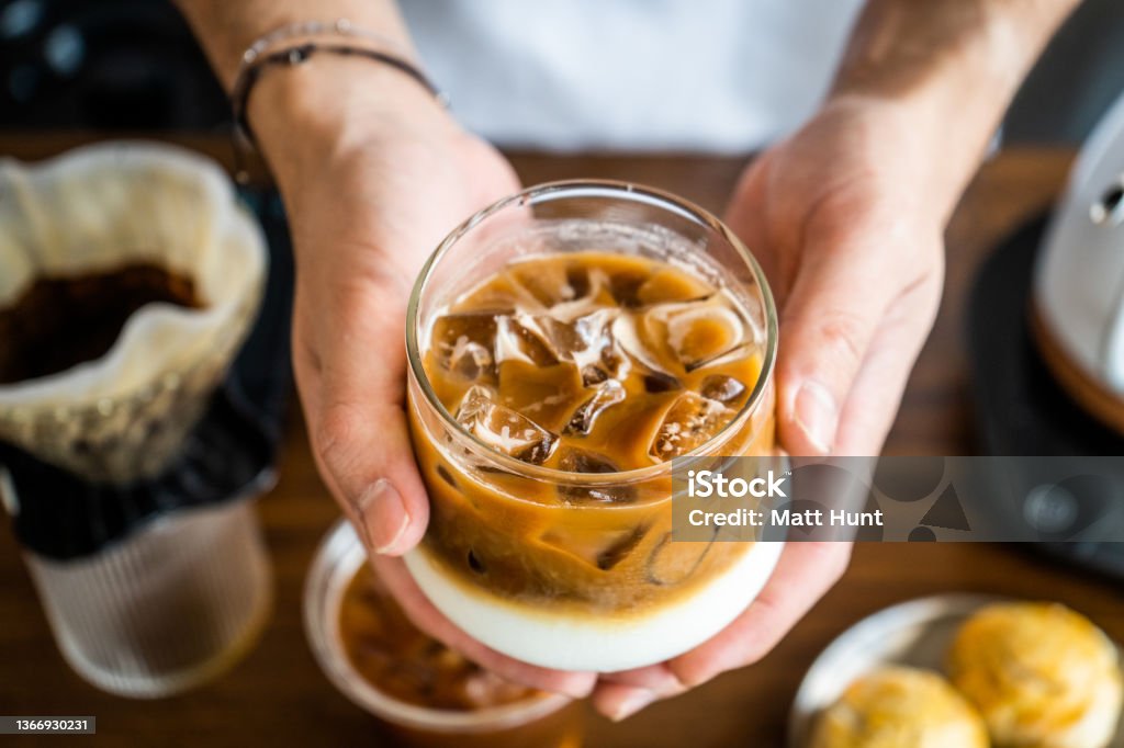 Asian male barista prepares coffee beverages in a cafe Asian (Thai) man prepares pour over drip coffee beverages at a cafe in Thailand Coffee - Drink Stock Photo