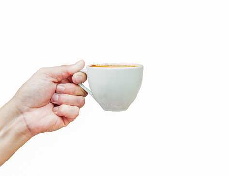 Front view of hot coffee cup in hand isolated on white background. Latte beverage in white mug the best start to any morning. Cut Out