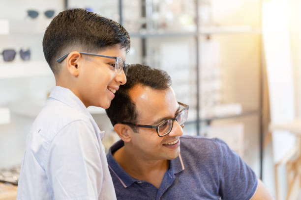 istock Indian father and son choosing eyeglasses in optics store 1366930894