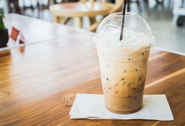 istock Iced coffee on wooden table at the cafe 1366930932